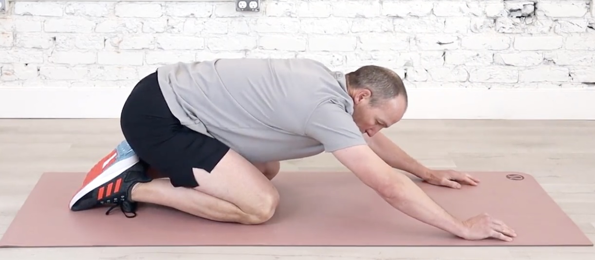 All-fours rocking: hands planted, hips moving back toward the heels