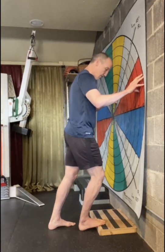 Soleus test: ball of the foot on a book against a wall, knee bent forward toward the toes, heel down
